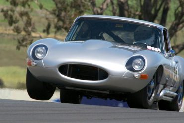 Jason Len three wheels over the crest in his 1964 Jaguar E-Type