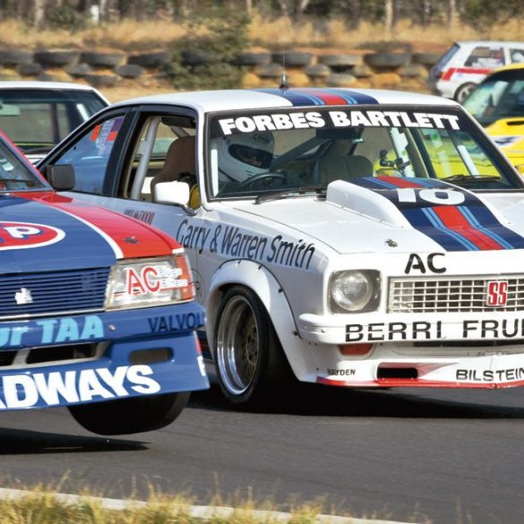 Edward Singleton (Holden Commodore) lifts a wheel on the outside line as Shaun Tunny looks for a way through in his Holden Torana A9X. Photo: Ian Welsh