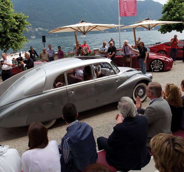 Karol Pavlu drives the distinctive 1939 Tatra 87 Sedan Aerodynamic into position next to lovely Lake Como.