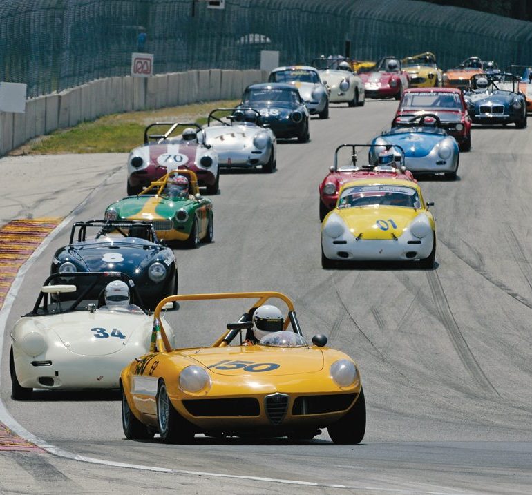 Mike Besic’s 1969 Alfa Romeo Spider leads the Group 2 field into Turn 5. He finished 1st in Sunday’s feature race. Photo: Jim Hatfield