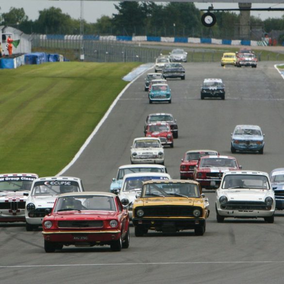 Mat Jackson’s Mustang leads the Alan Mann Trophy field away from the start. Photo: Pete Austin