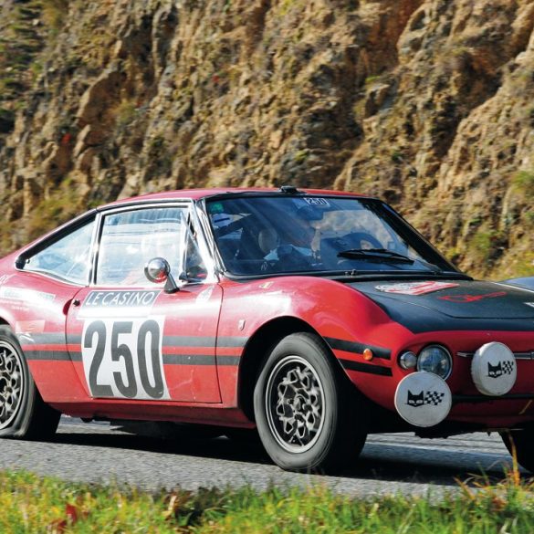 Didier Lodewyckx and Pat Lambert’s Fiat 850 Moretti limps alomg on a flat tire. Photo: Peter Collins