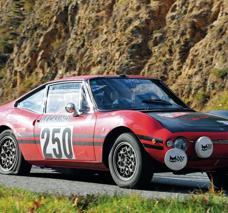 Didier Lodewyckx and Pat Lambert’s Fiat 850 Moretti limps alomg on a flat tire. Photo: Peter Collins