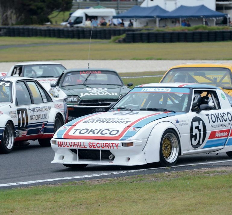 Looking a little crowded. The Mazda RX-7 of Christopher Bowden with the Holden Commodore of Jeff Trembath on the inside. Photo: Neil Hammond