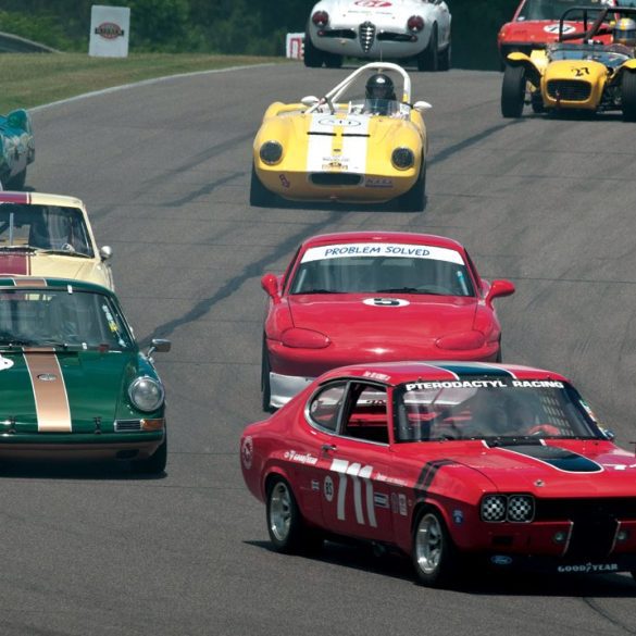 Ira Schoen’s Ford Capri leads George Calfo’s Porsche 911S and a host of others into the downhill sweeper. Photo: Chuck Andersen