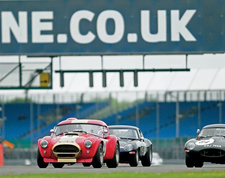 The Bryant AC Cobra heads a pair of Jaguar E-Types into Copse. Photo: Peter Collins