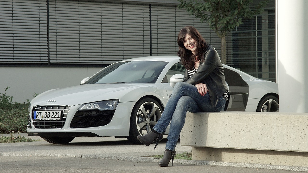 Woman sitting in front of her Audi R8