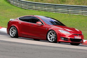 A side view of a Tesla Model S Plaid being tried out on the track