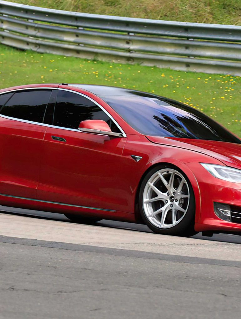 A side view of a Tesla Model S Plaid being tried out on the track