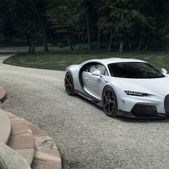 A view of a Bugatti Chiron parked at a driveway of a large staircase.