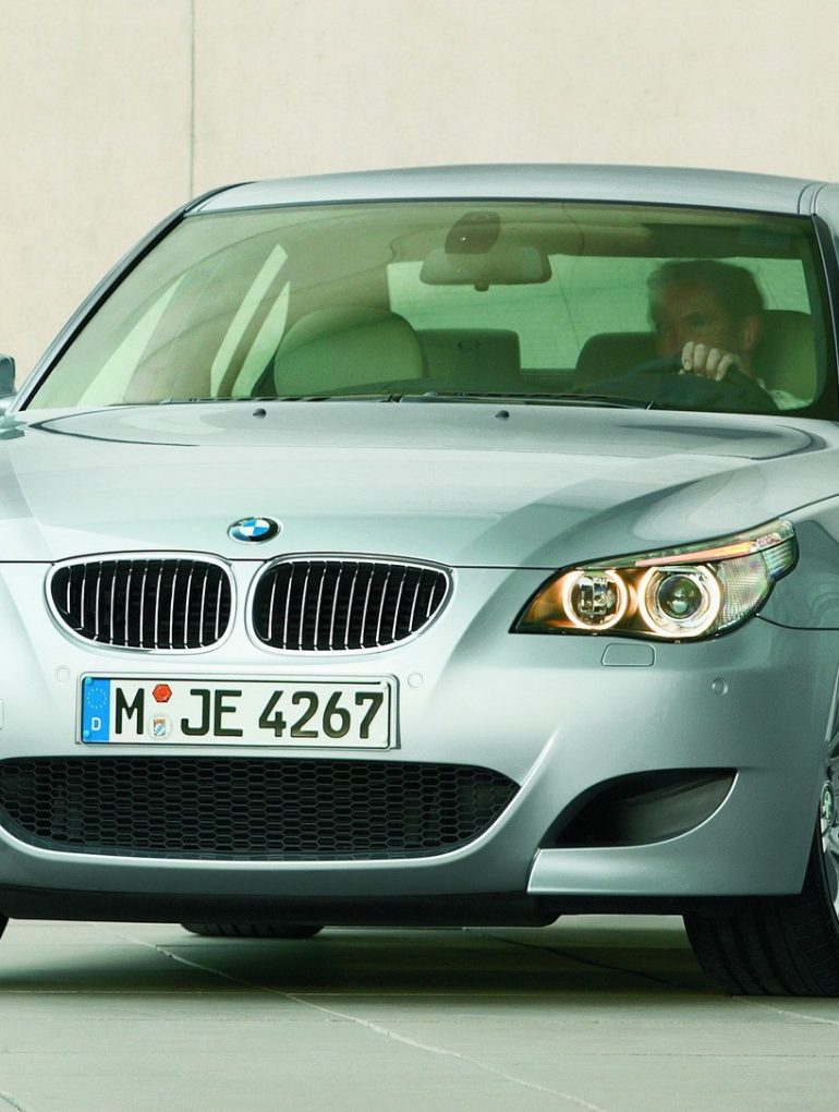 Silver 2005 BMW M5 parked in showroom