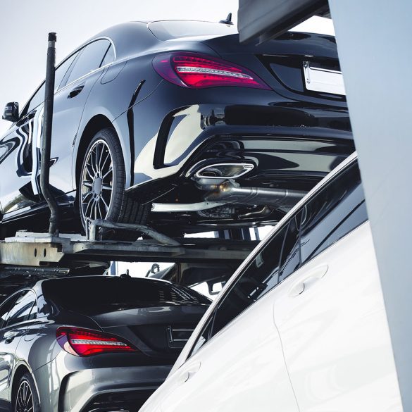 Mercedes Benz vehicles being transported on a car carrier truck.