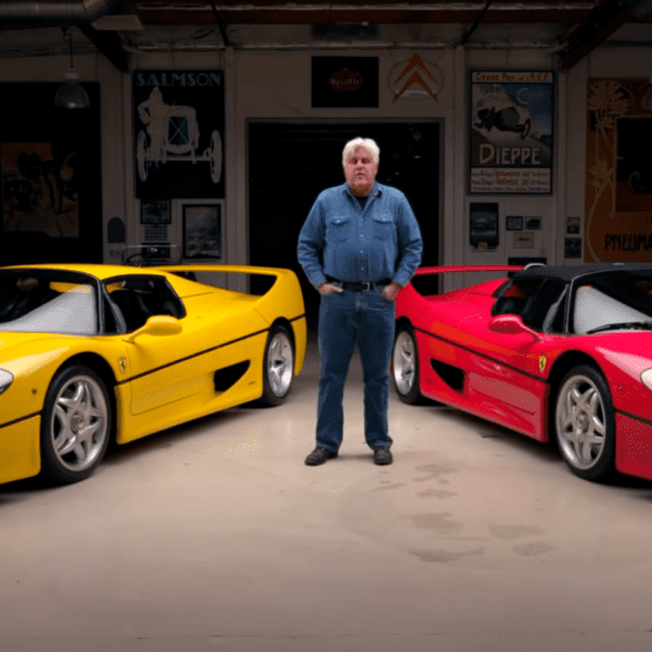 Jay Leno standing in front of yellow and red Ferrari F50