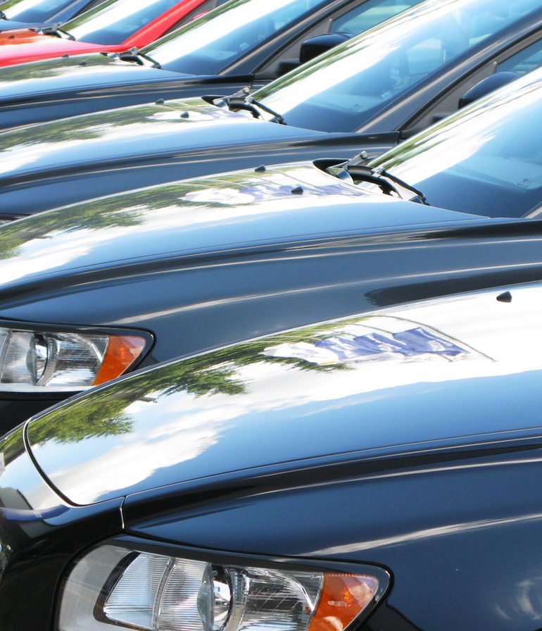 Cars parked side by side in a lot