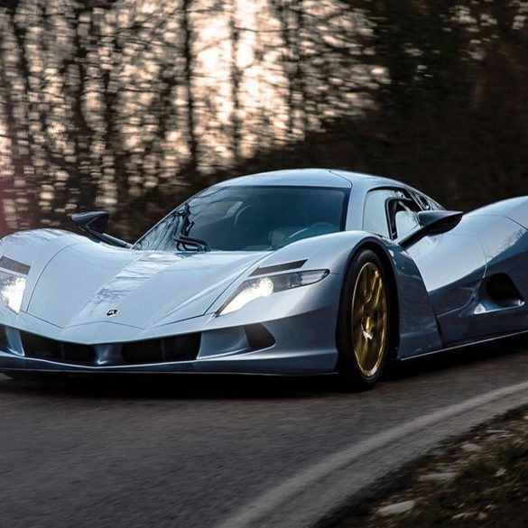 Silver Aspark Owl fully electric hypercar on a curvy road