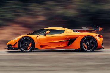 Rolling shot of an orange Koenigsegg Jesko hypercar