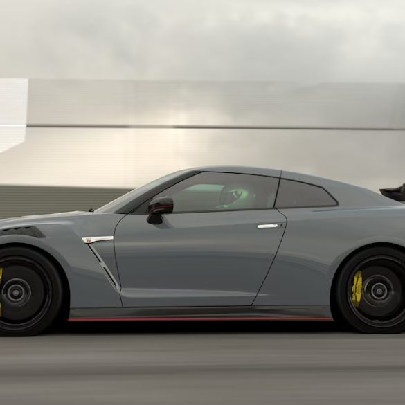 A rolling shot of a grey Nissan GT-R showing its side profile.