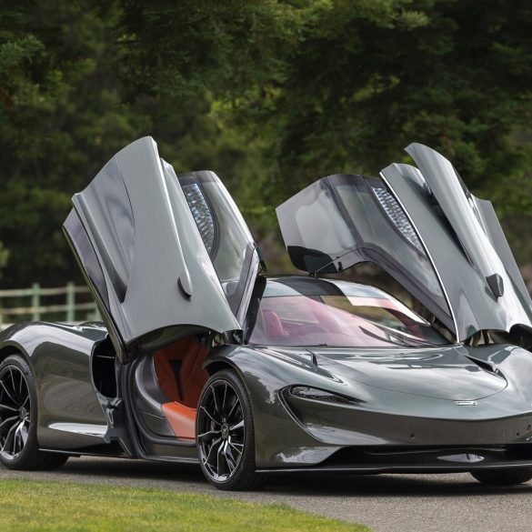 Front-angled view of a 2020 Grey McLaren Speedtail with butterfly doors open.