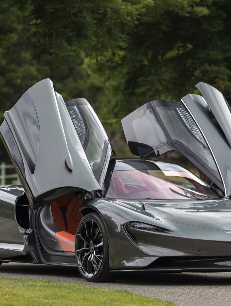 Front-angled view of a 2020 Grey McLaren Speedtail with butterfly doors open.