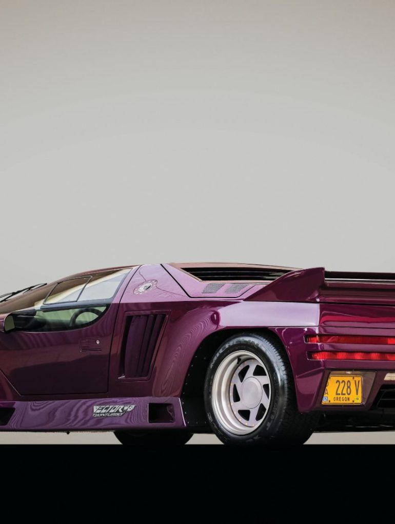 Image showing the rear-angled profile of a purple Vector W8 supercar.