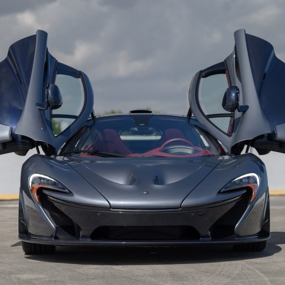 Front view of a grey 2015 McLaren P1 with butterfly doors open