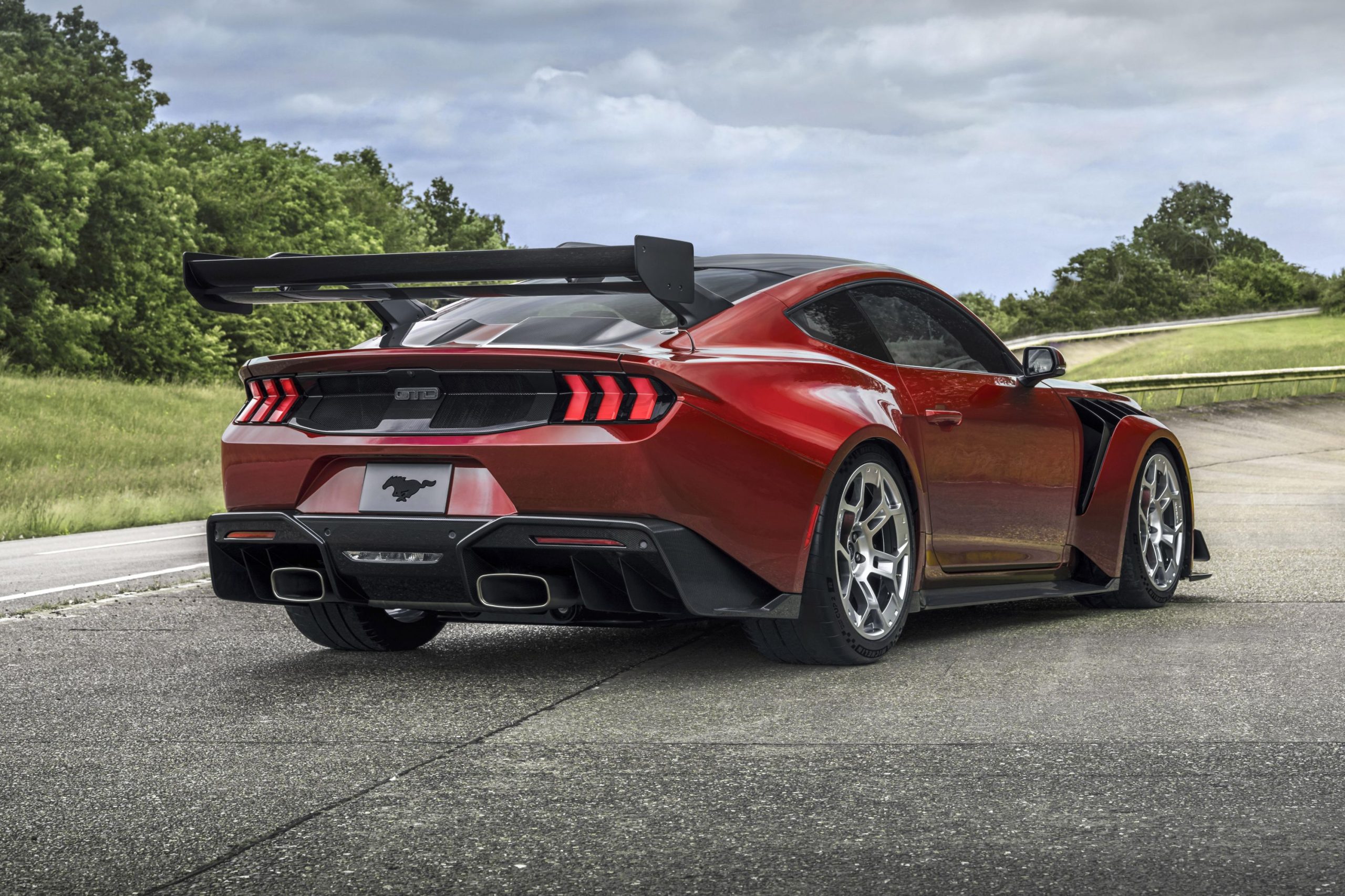 Rear-angled view of a red Ford Mustang GTD